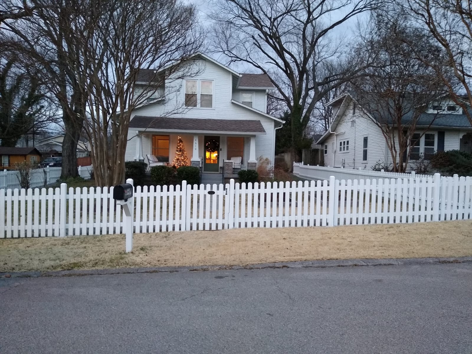 Beautiful Nashville home with freshly painted white picket fence by Lopez Painting